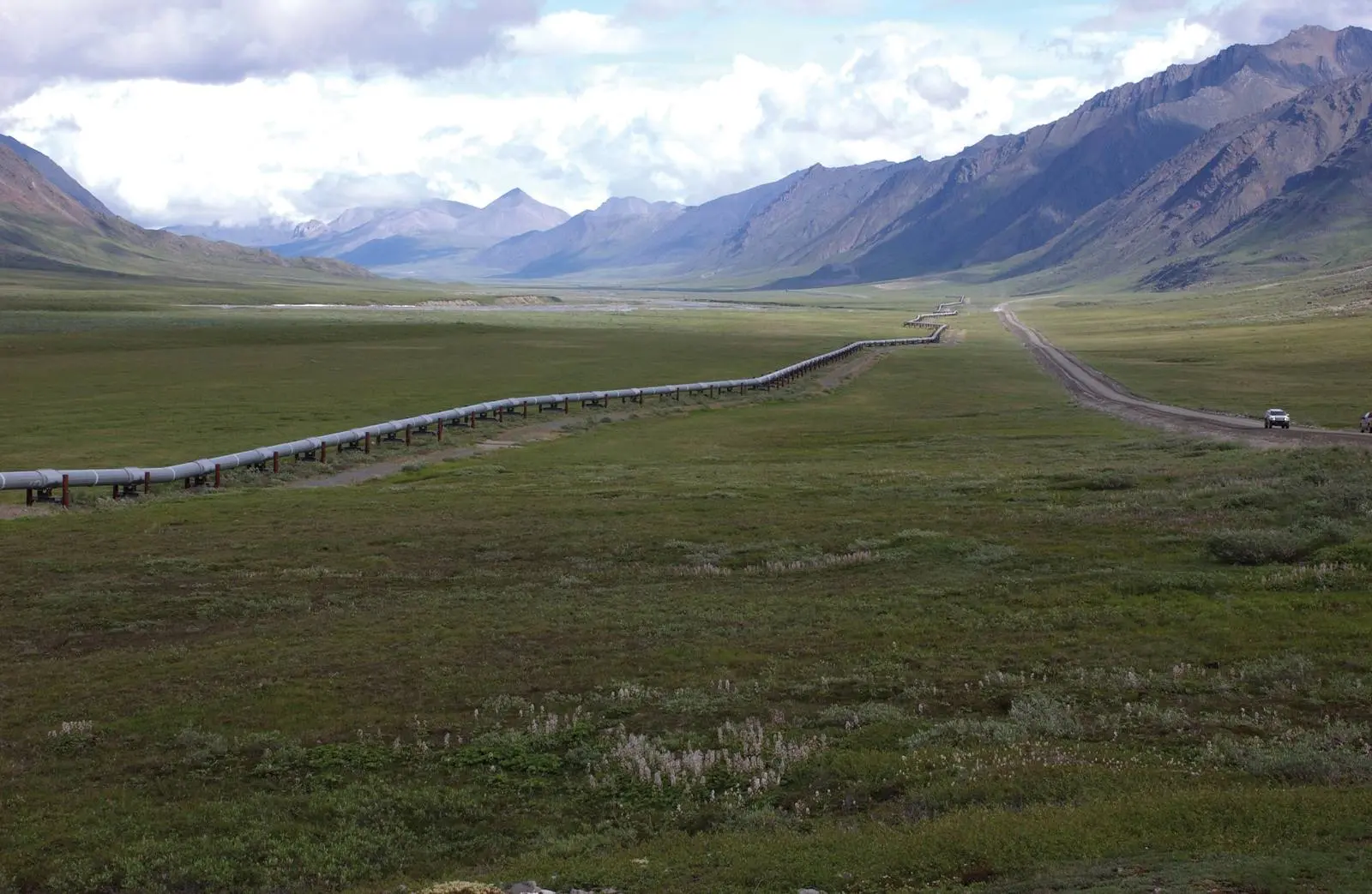The trans-Alaska pipeline and the Dalton Highway run north through the Brooks Range toward Prudhoe Bay.