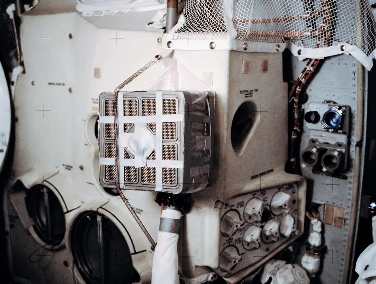 The “mailbox”: square command module canisters taped into Aquarius’s air system to scrub carbon dioxide (AS13-62-8929)