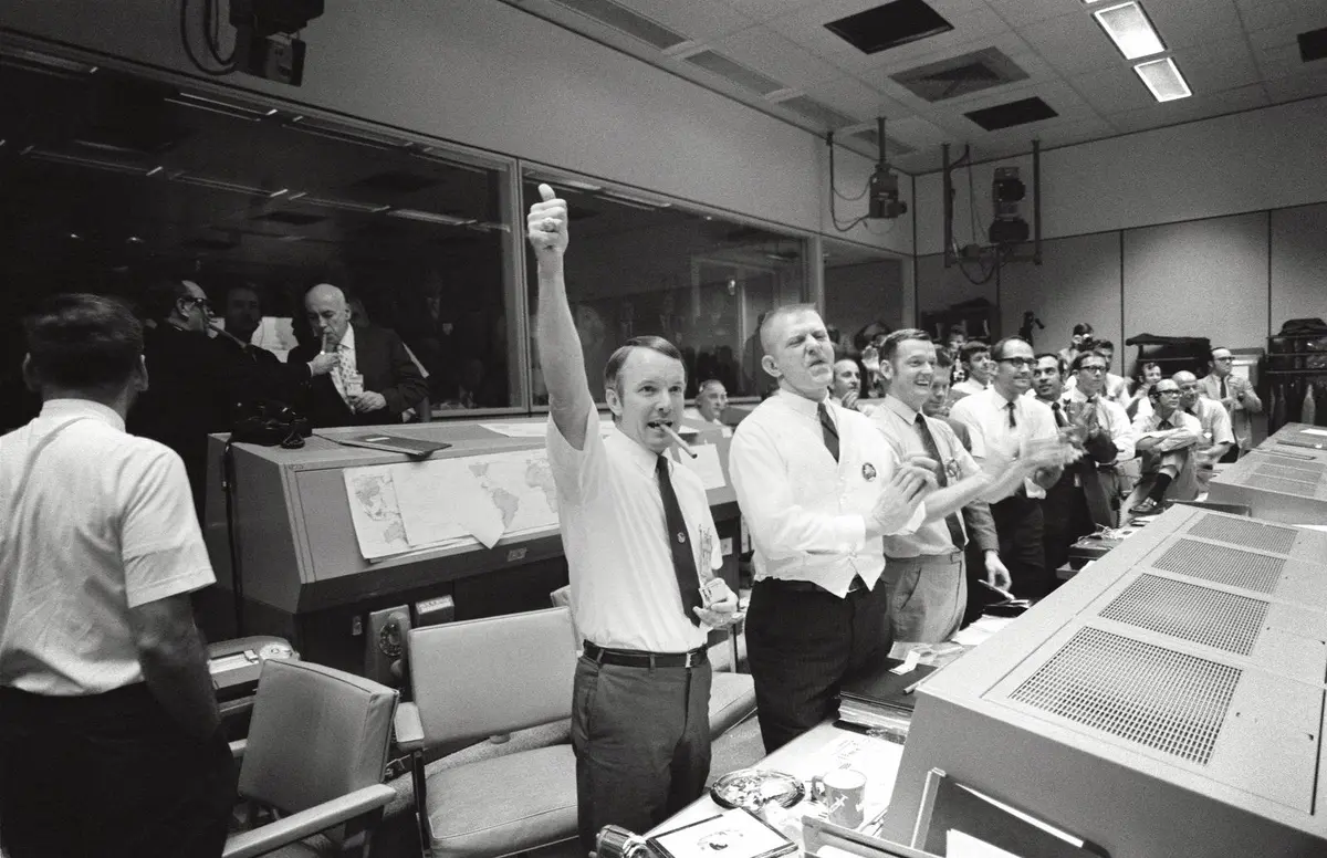 Flight directors Gerry Griffin, Gene Kranz and Glynn Lunney cheer the splashdown in Mission Control, 17 April 1970
