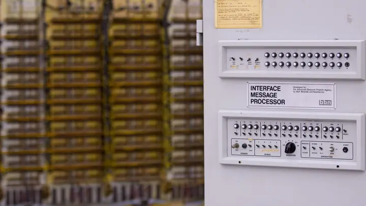 An Interface Message Processor built by BBN for ARPA, at the Computer History Museum, with SAGE air-defense computer racks behind it