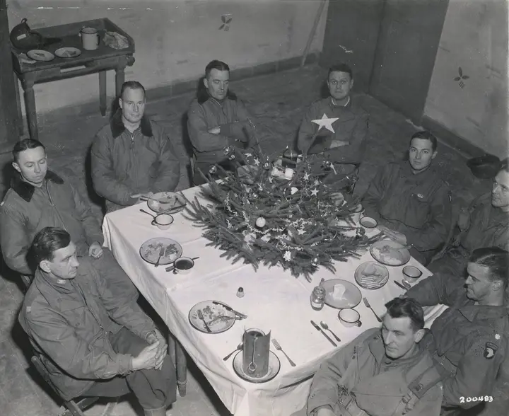 Brig. Gen. Anthony McAuliffe and his staff at Christmas dinner in the Heintz Barracks, Bastogne, 25 December 1944