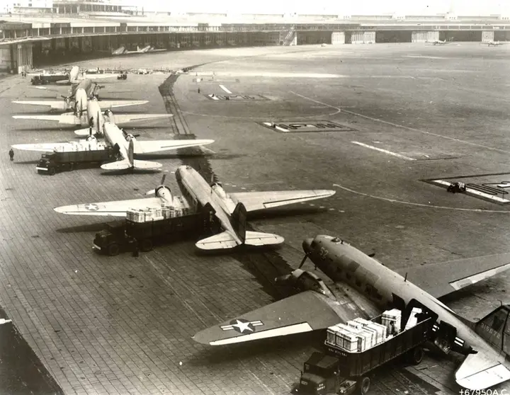 Air Force C-47s in the unloading line at Tempelhof. In the first weeks of the airlift these small twin-engine transports carried everything from engine crates to milk bottles.
