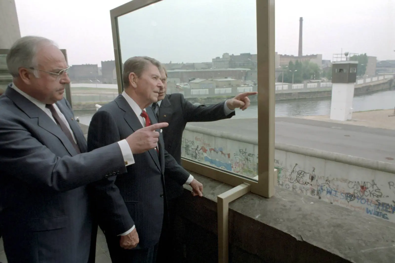 Reagan and Chancellor Helmut Kohl look over the Wall into East Berlin from the Reichstag before the speech, 12 June 1987