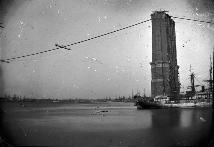 A finished tower and the first wire ropes strung over the East River, about 1876.