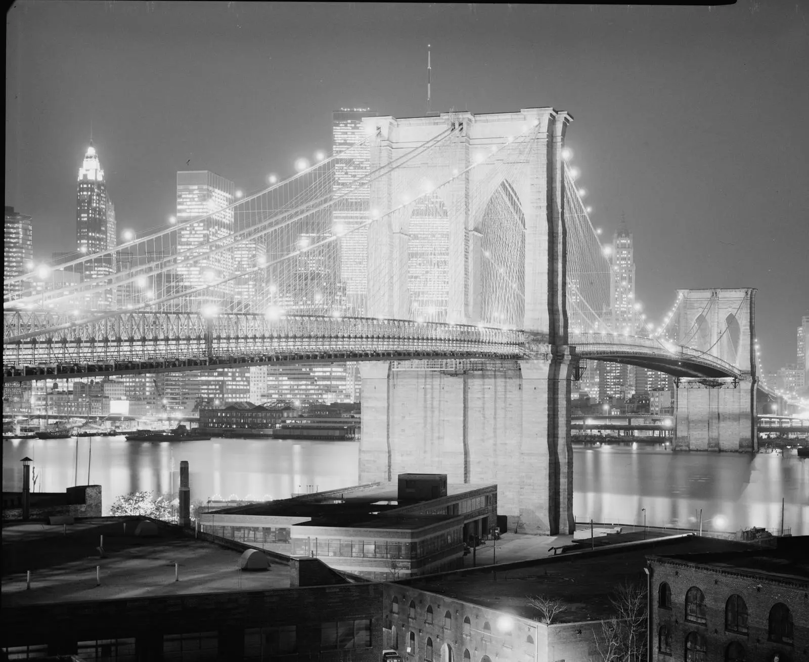 The bridge lit up at night against Lower Manhattan, 1982.