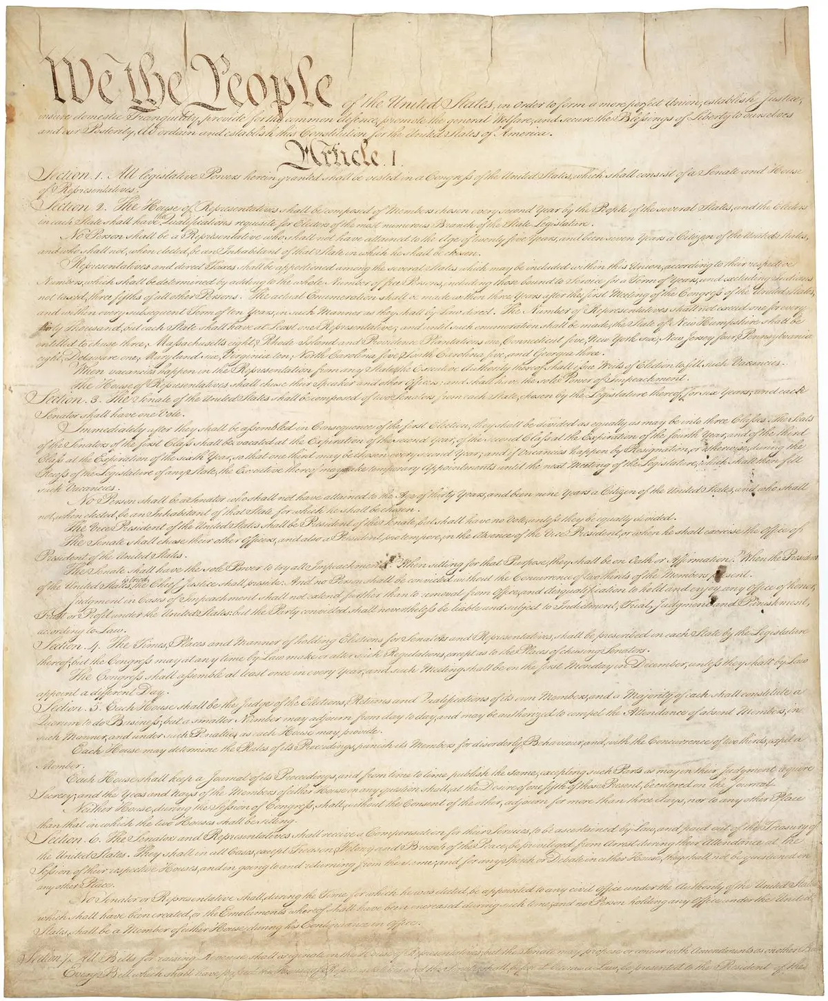 Page one of the signed Constitution, opening with the words We the People.
