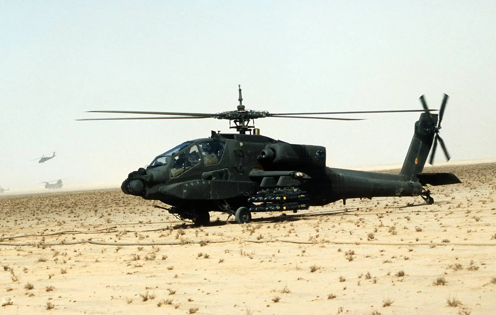 An AH-64A Apache of the XVIII Airborne Corps, armed with Hellfire missiles, is readied for a mission, 27 February 1991.