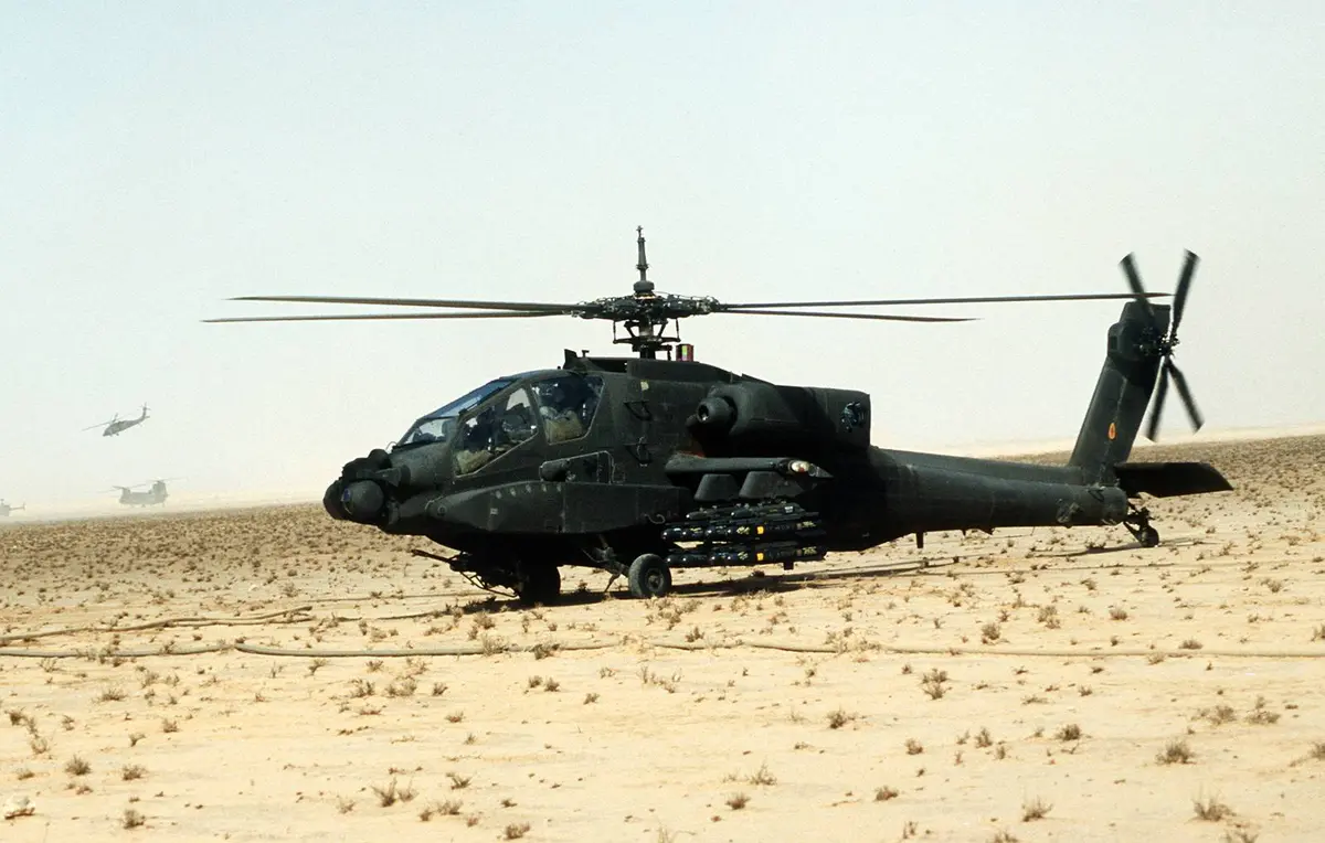 An AH-64A Apache of the XVIII Airborne Corps, armed with Hellfire missiles, is readied for a mission, 27 February 1991.