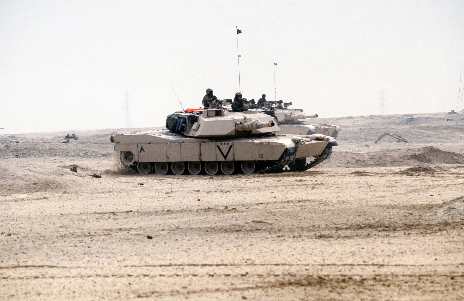 Marine M1A1 Abrams tanks cross the Kuwaiti desert on the first day of the ground war, 24 February 1991.