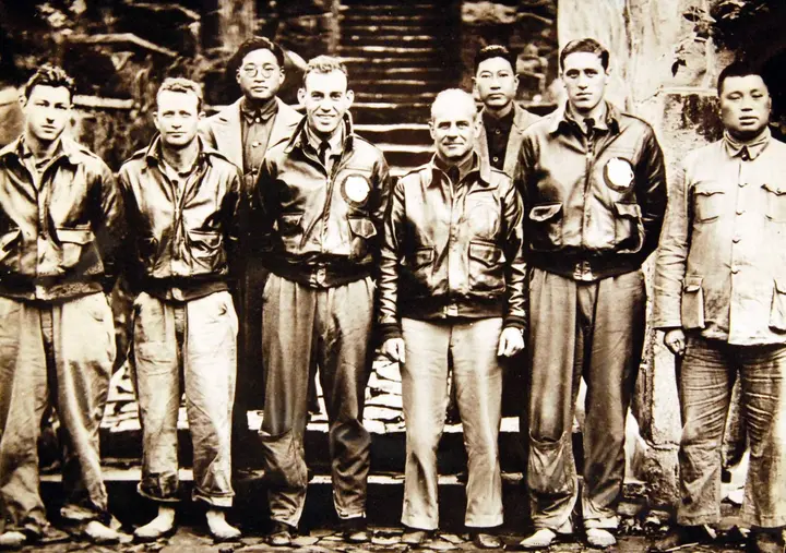 Doolittle (center) and his crew with Chinese officials who helped them in Chekiang Province after the raid (208-N-9092-P).