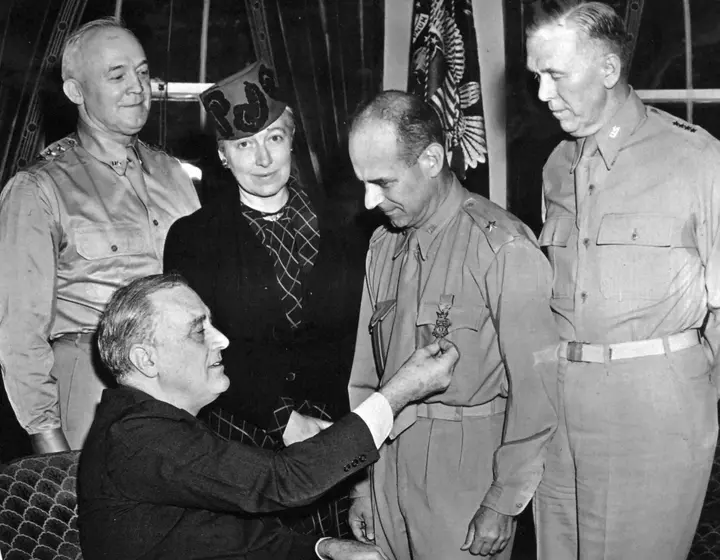 President Roosevelt presents the Medal of Honor to Brig. Gen. Jimmy Doolittle at the White House, 19 May 1942, as Lt. Gen. Hap Arnold, Josephine Doolittle and Gen. George Marshall look on (208-PU-52-LL-12).