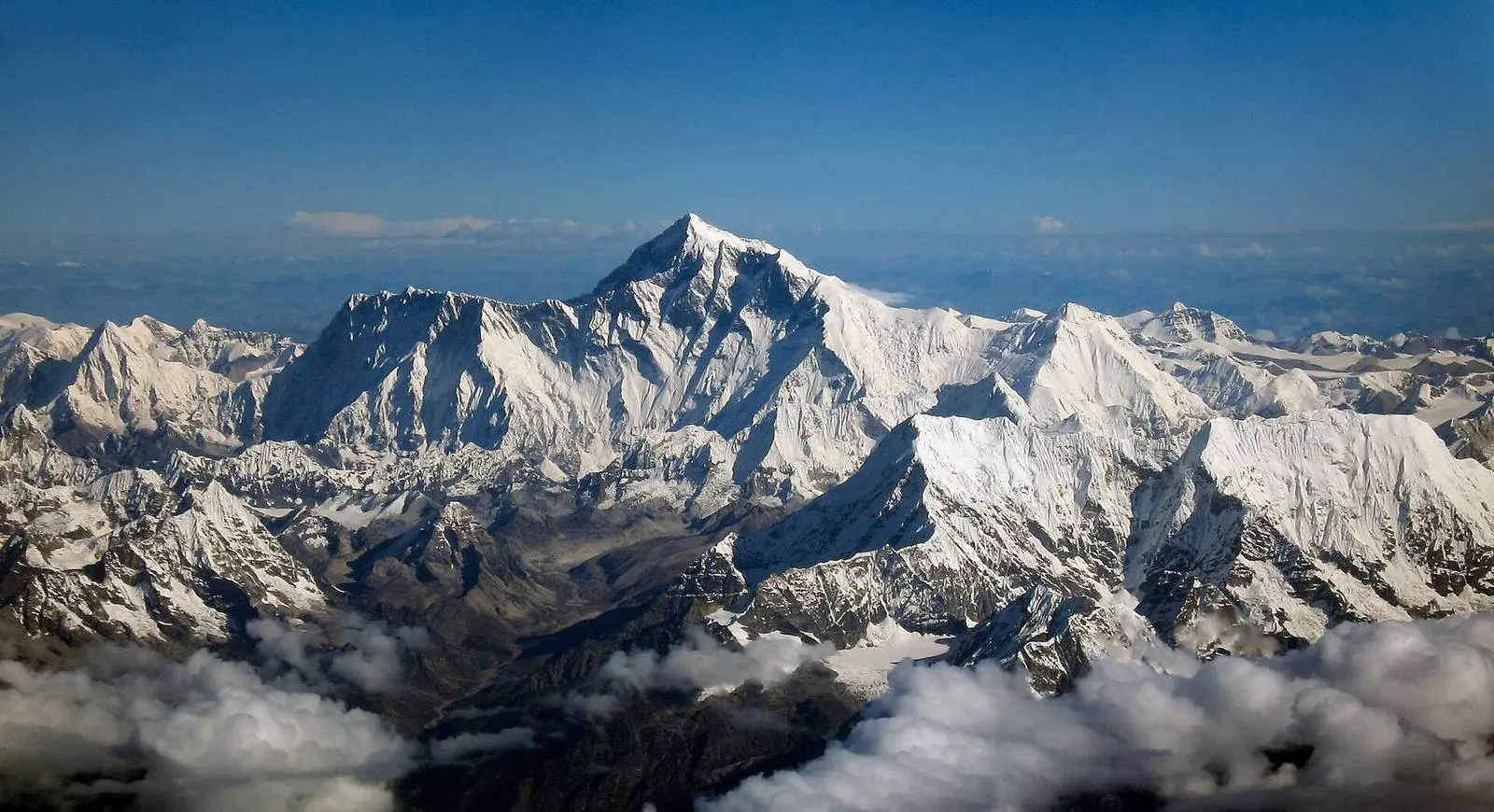 Everest rises above the Nuptse–Lhotse wall, seen from a Drukair flight south of the Himalaya.