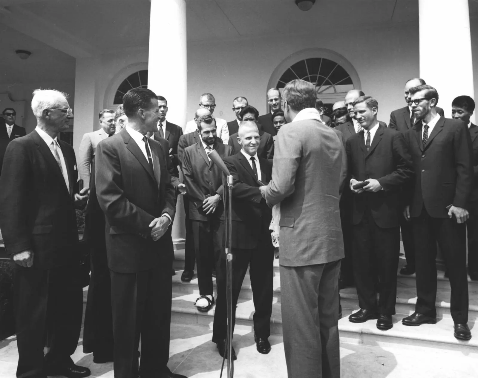 President Kennedy, wearing the white kata Nawang Gombu gave him, greets the Everest team in the Rose Garden, 8 July 1963.
