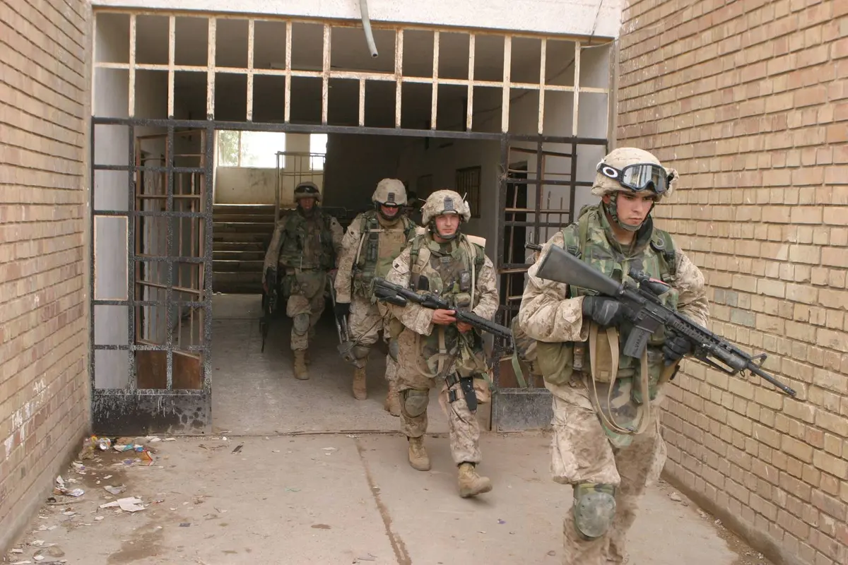Marines of K Company, 3d Battalion, 5th Marines, seize an apartment complex at the edge of Fallujah in the first hours of the assault, 8 November 2004.