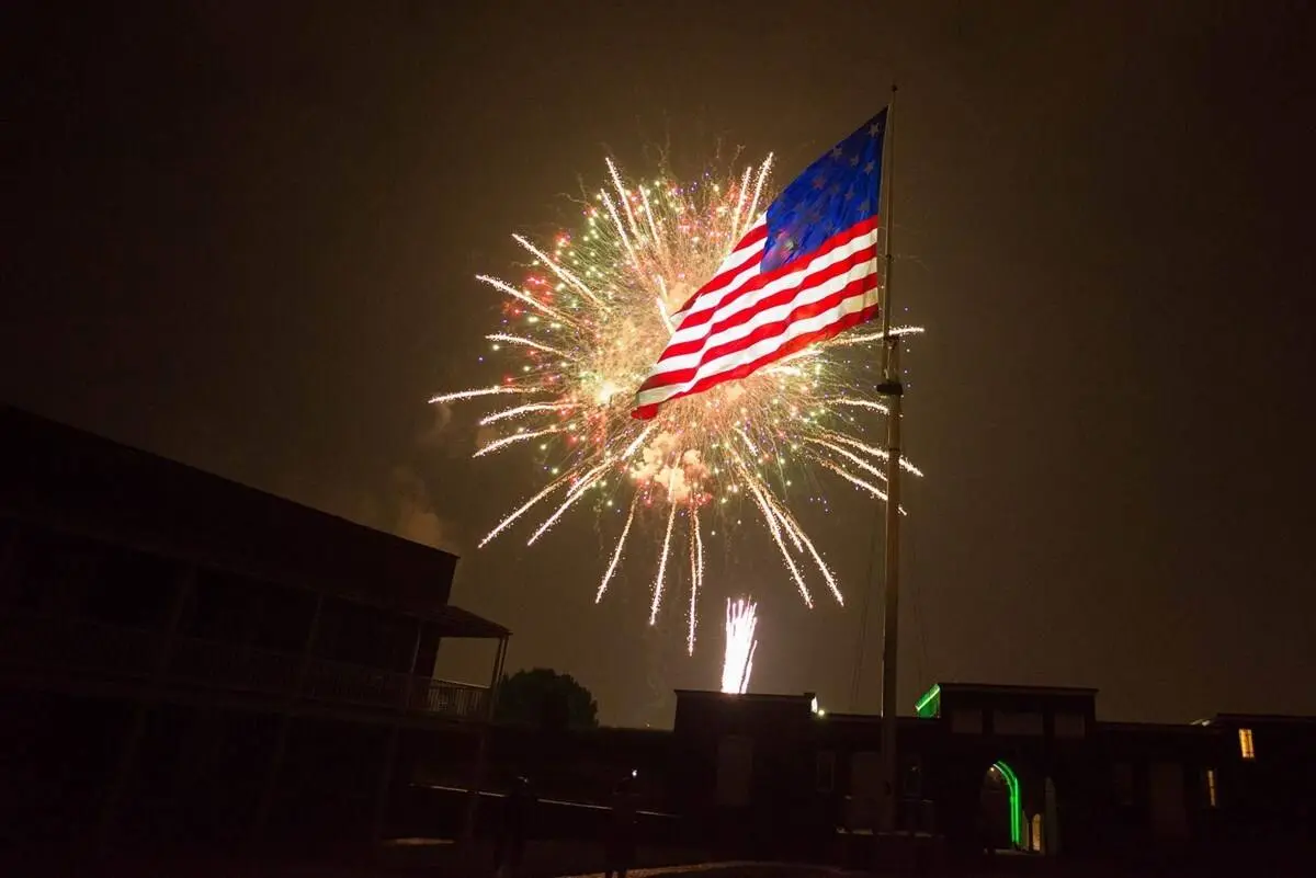 Fireworks burst behind a 15-star flag over Fort McHenry on the anniversary of the battle.