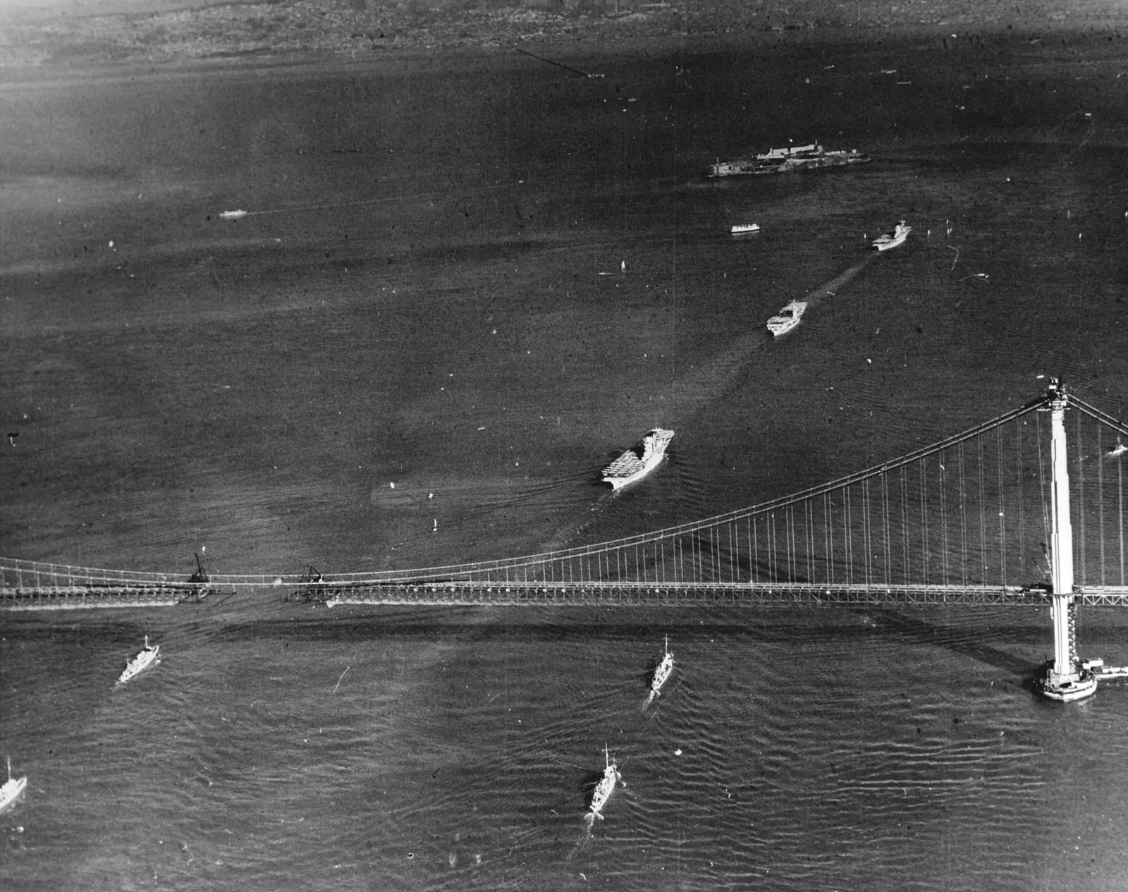 The aircraft carriers Lexington, Ranger and Saratoga steam under the unfinished bridge, 12 November 1936.