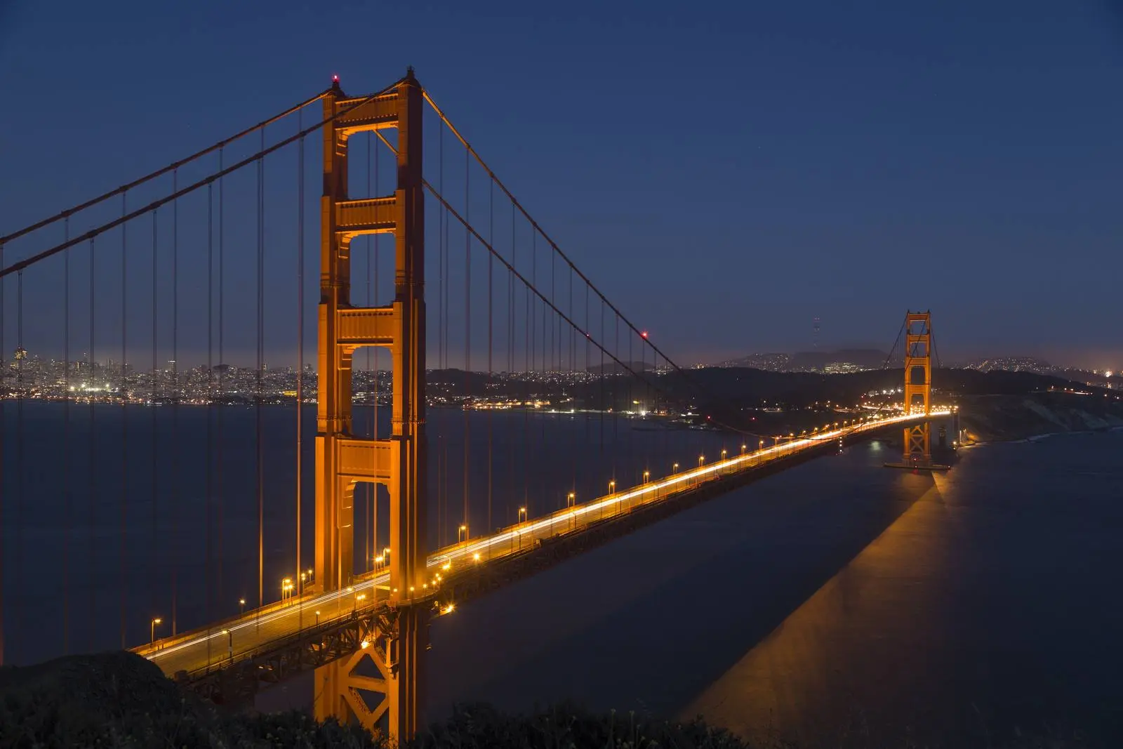 The Golden Gate Bridge lit up at night, seen from the Marin side, May 2012.