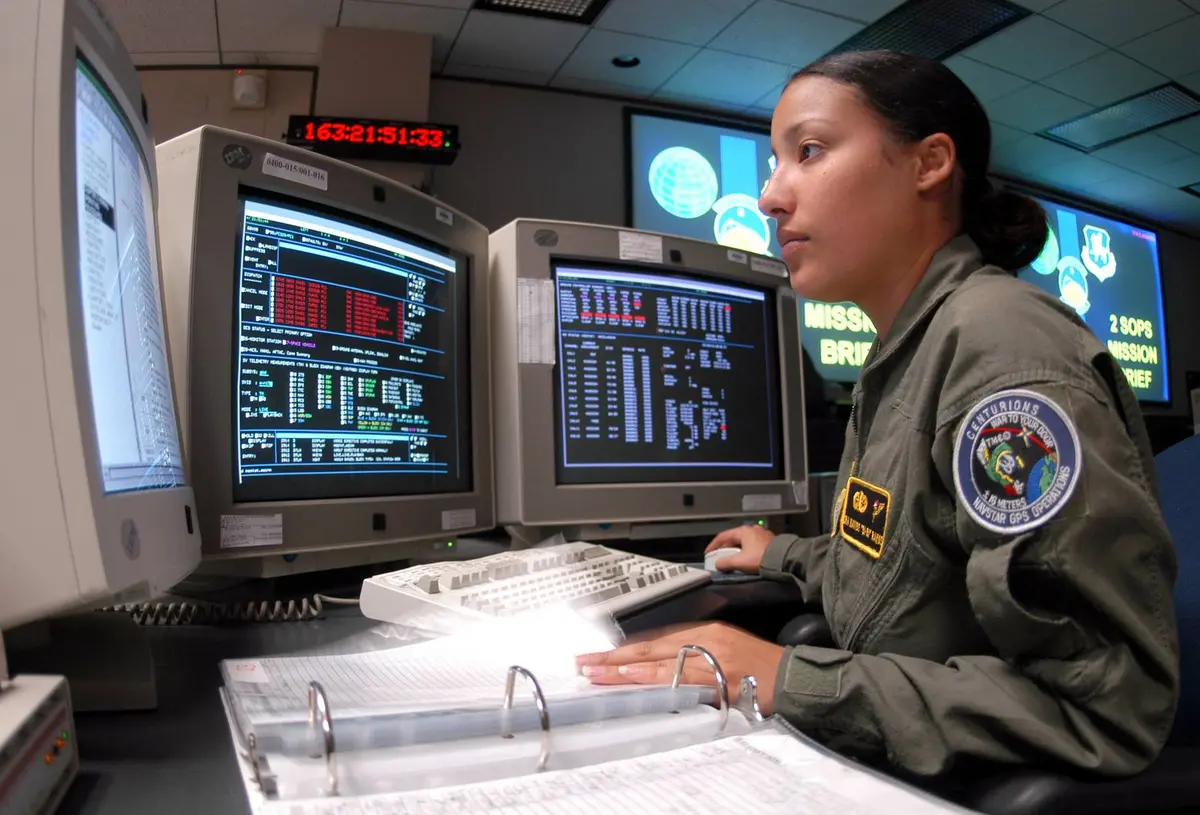 Senior Airman Nayibe Ramos runs a checklist during GPS satellite operations with the 2nd Space Operations Squadron at Schriever Air Force Base, Colorado, in 2004.