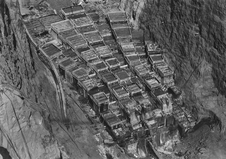 Boulder (Hoover) Dam column blocks rising in Black Canyon, telephoto from cableway control tower, c. 1934