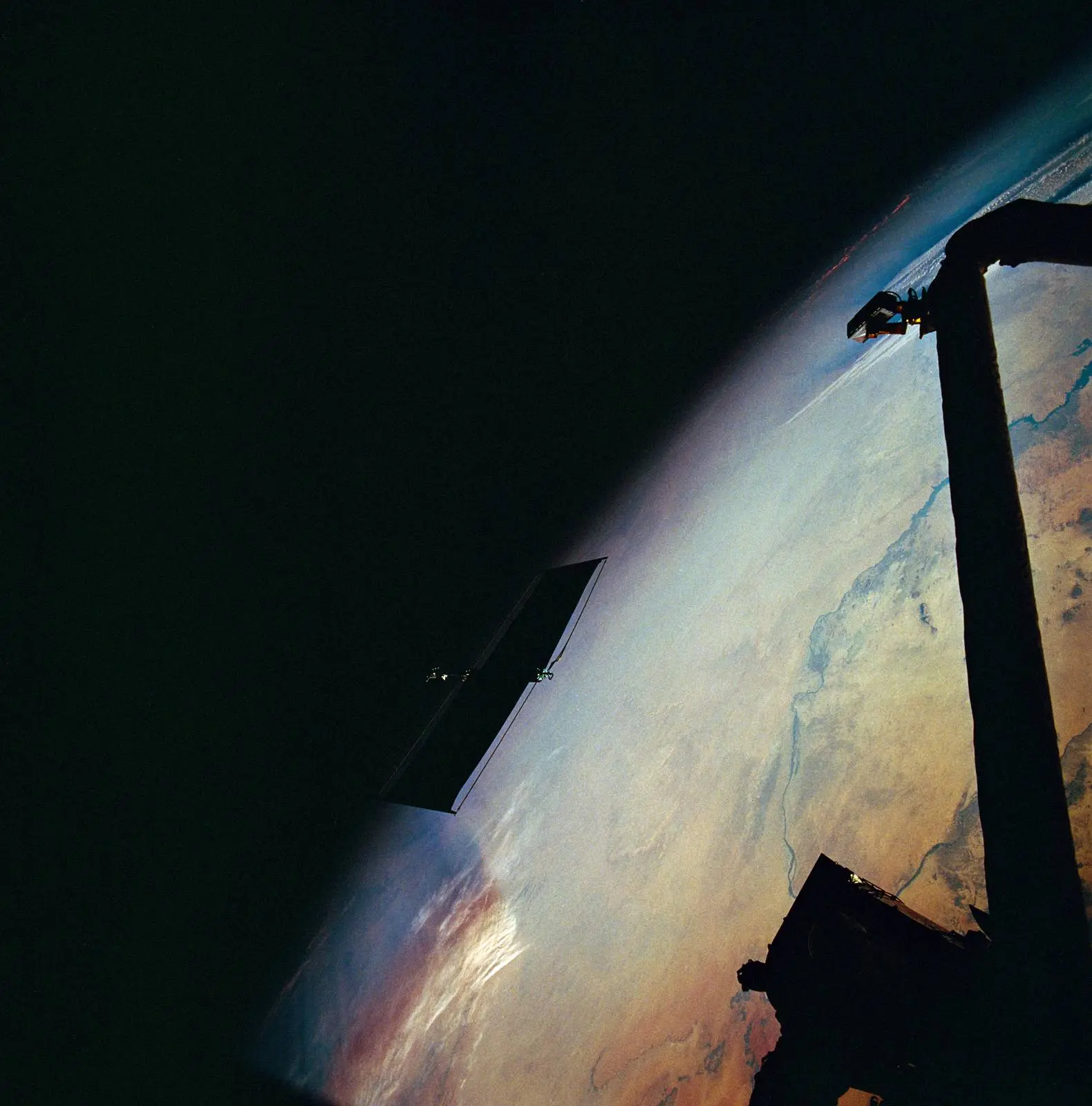 Hubble’s old, damaged solar array drifts away over northern Sudan moments after Kathryn Thornton released it by hand on the second spacewalk, 6 December 1993 (STS061-95-031).