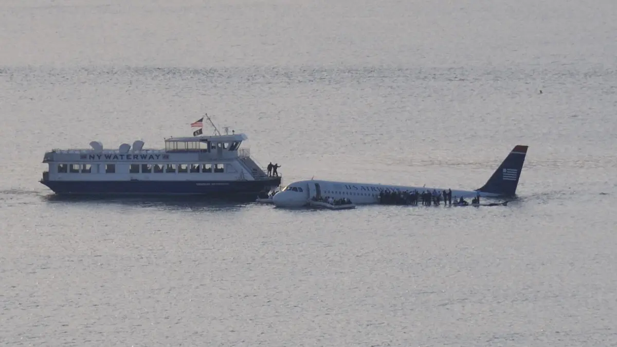 The NY Waterway ferry Thomas Jefferson, Capt. Vincent Lombardi, pulls alongside Flight 1549 as passengers wait on the wings, 15 January 2009