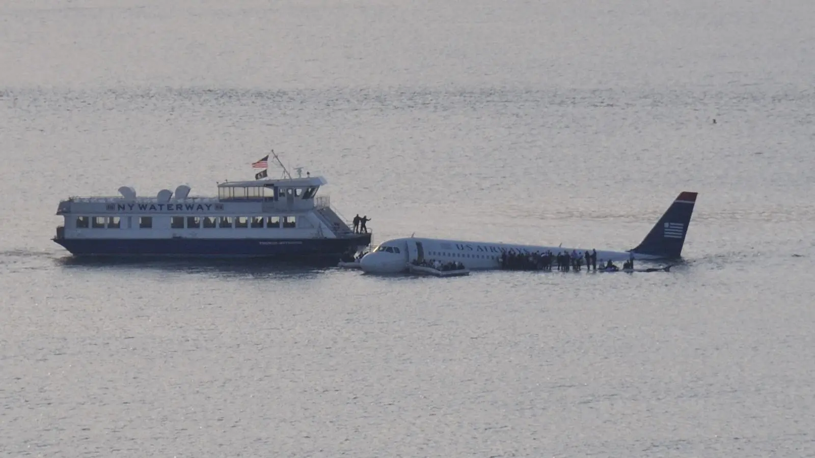 The NY Waterway ferry Thomas Jefferson, Capt. Vincent Lombardi, pulls alongside Flight 1549 as passengers wait on the wings, 15 January 2009