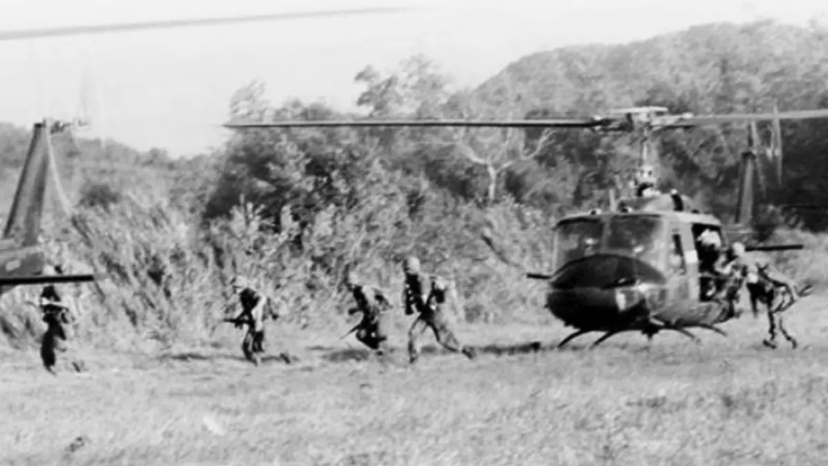 Troopers of the 1st Cavalry Division run from their Hueys into the elephant grass in the Ia Drang Valley, November 1965.