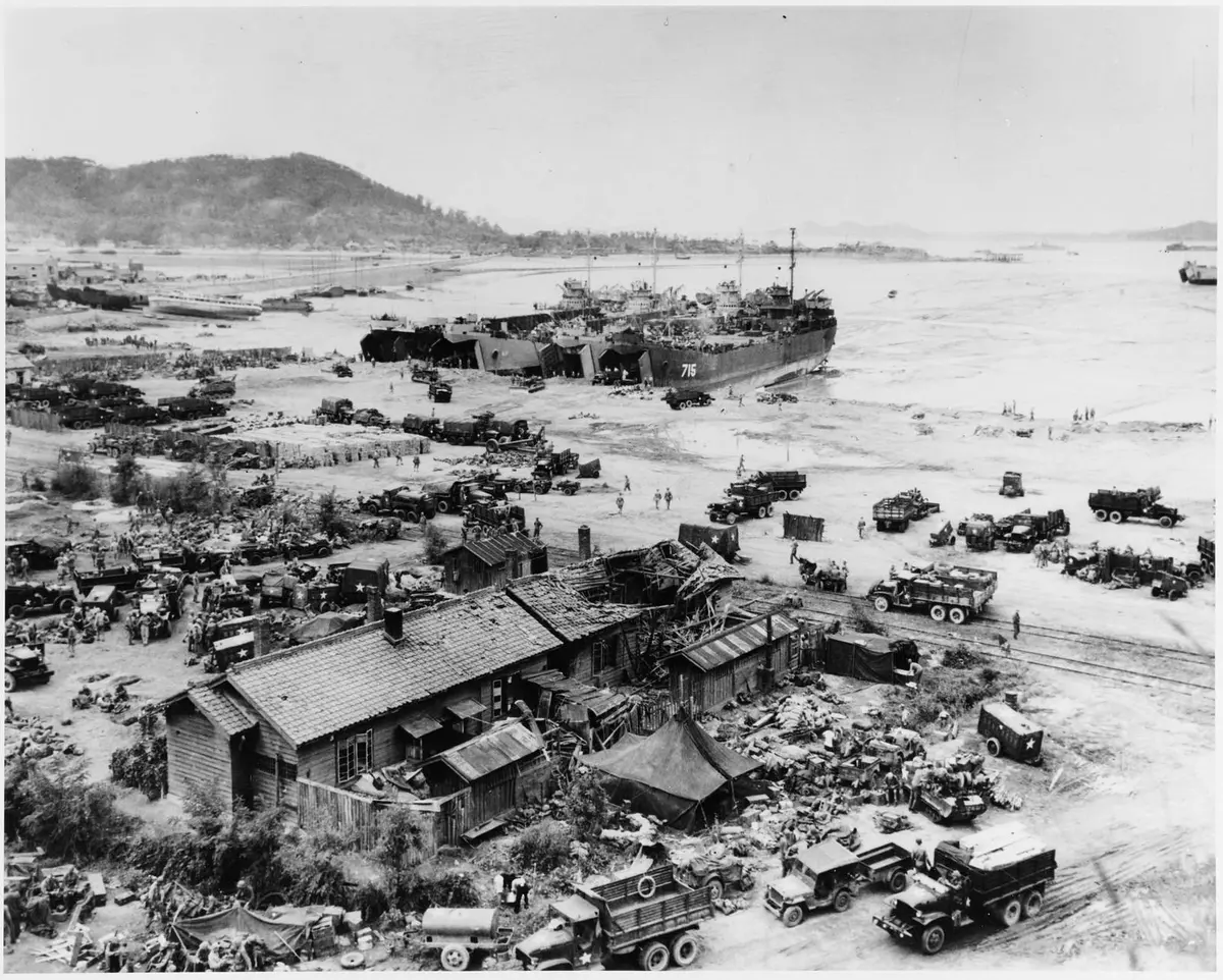 LSTs sit high and dry on the mudflats of Red Beach at low tide, unloading trucks and men the day after the landing, 16 September 1950 (80-G-420027).