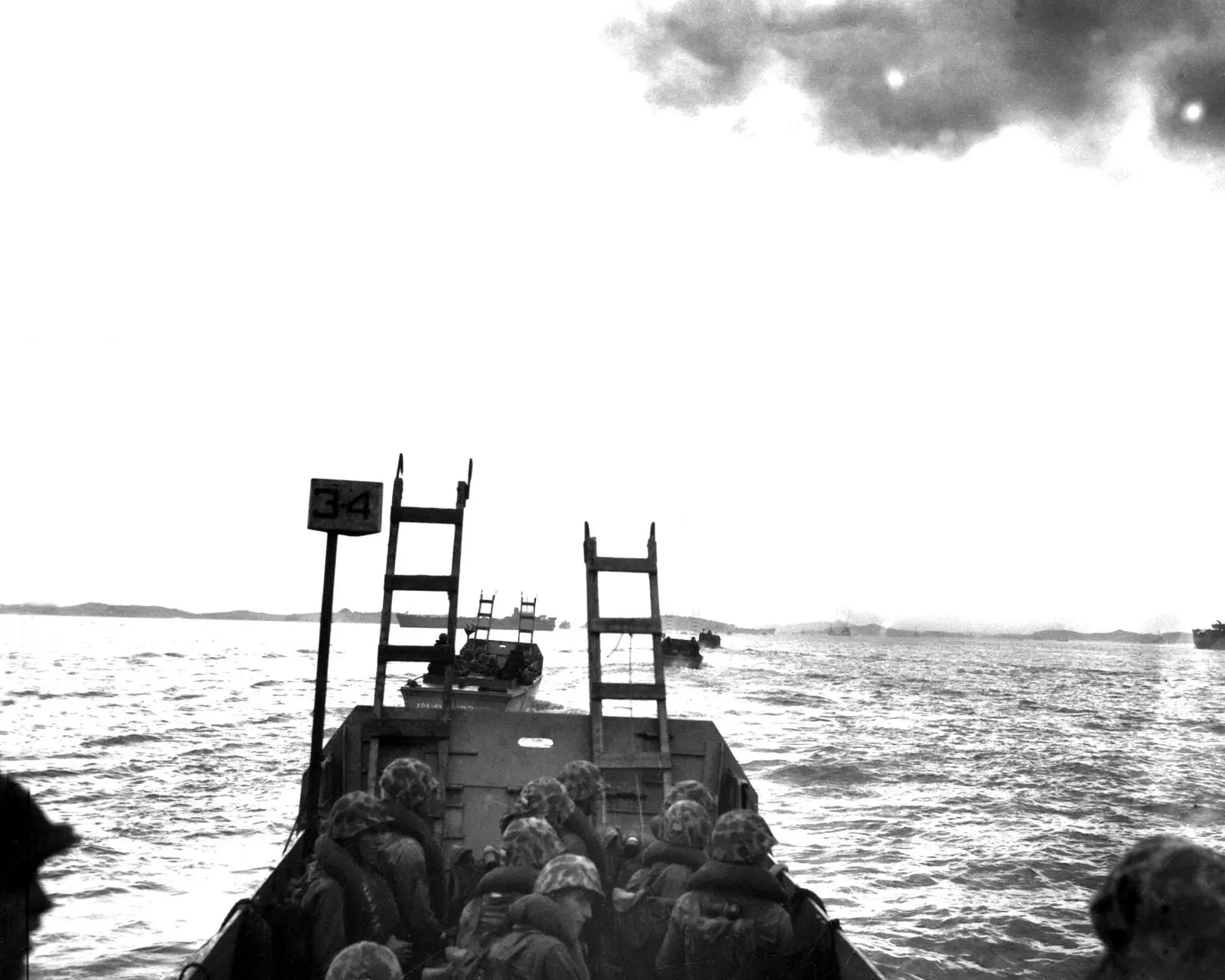 Marines ride in toward the Inchon seawall with their scaling ladders up, 15 September 1950 (127-N-A3189).