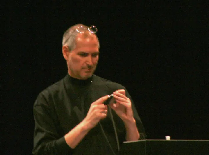 Steve Jobs holds the iPhone during his Macworld keynote, 9 January 2007