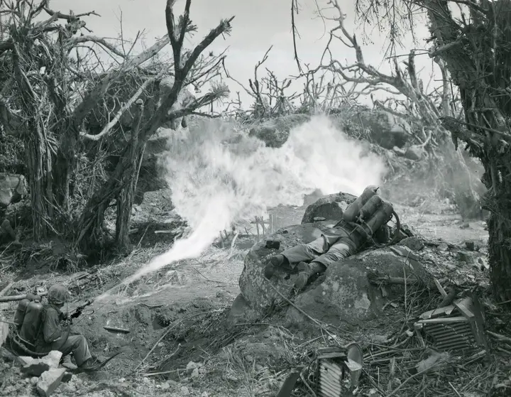 Pvt. Richard Klatt and PFC Wilfred Voegeli burn out Japanese defenses below Mount Suribachi, February 1945