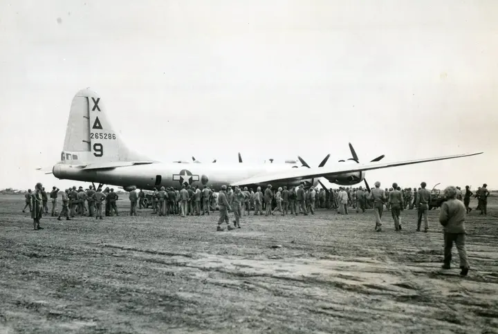 Marines crowd around the B-29 "Dinah Might," the first Superfortress to make an emergency landing on Iwo Jima, 4 March 1945