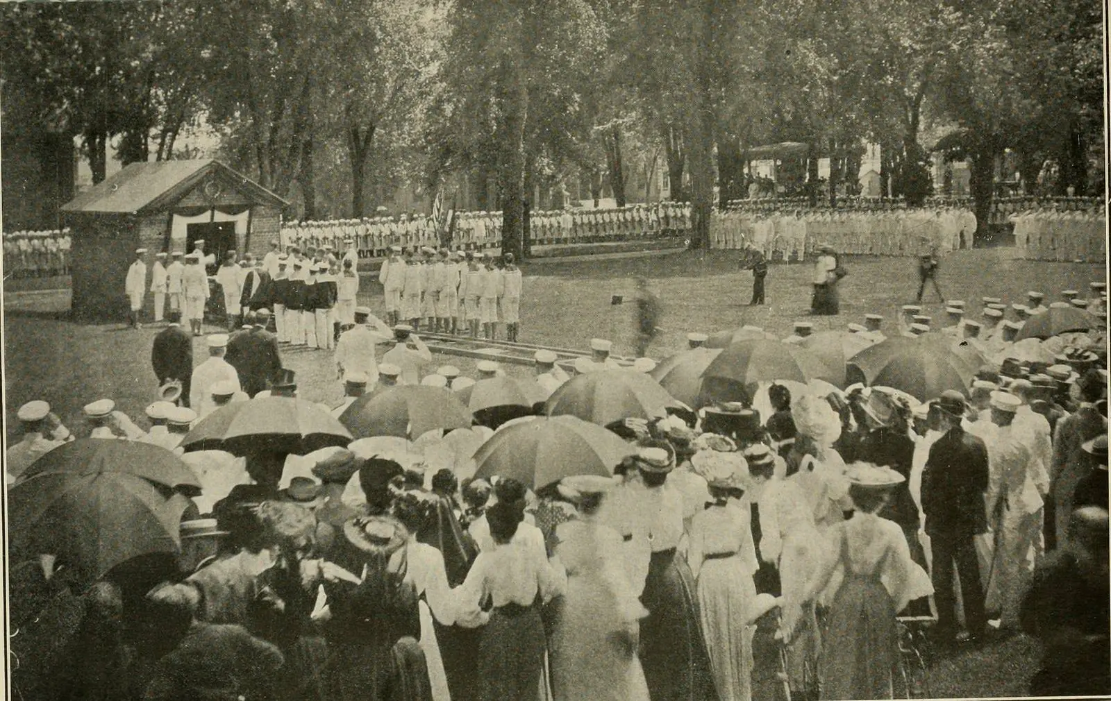 Midshipmen and crowds under umbrellas at the Naval Academy for the ceremonies honoring Jones on his return, 24 July 1905.