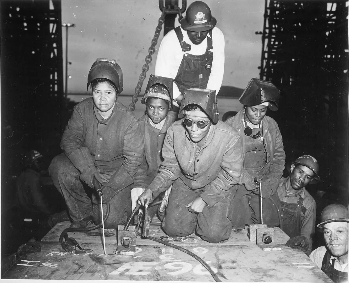 Welders Alivia Scott, Hattie Carpenter and Flossie Burtos get ready to weld their first piece of steel at the Kaiser yards in Richmond, California, about 1943.