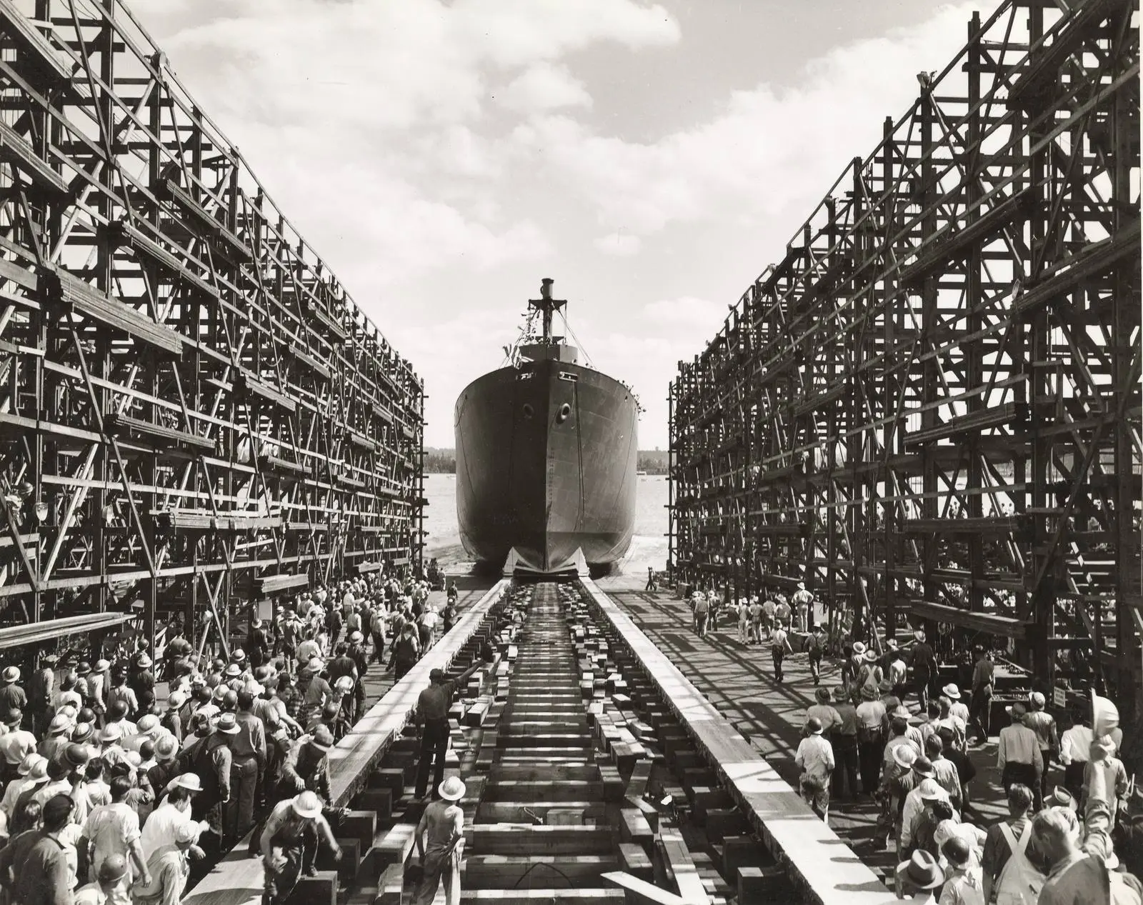 Workers crowd the ways as a newly launched Liberty ship leaves its building dock at the Kaiser yard in Vancouver, Washington.