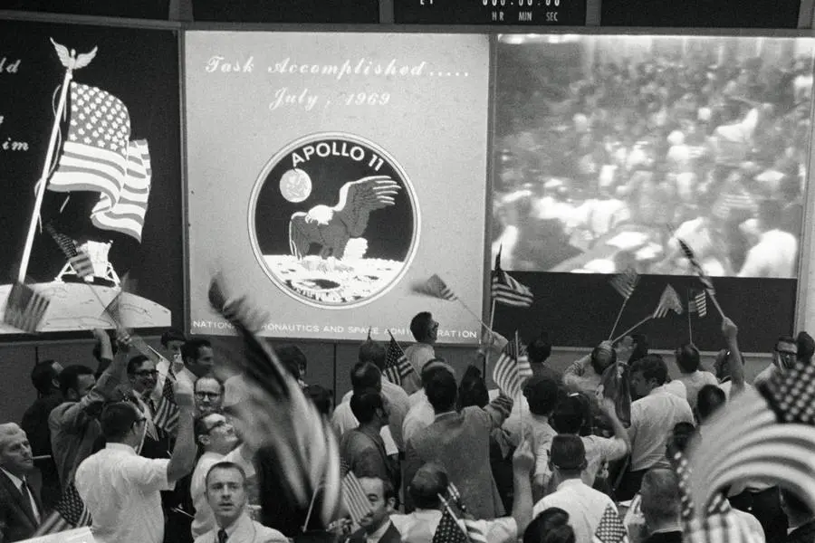 Flight controllers celebrate the end of Apollo 11 in Mission Control, July 24, 1969 (S69-40023)