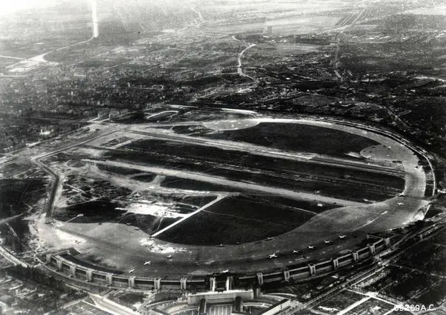 Aerial view of Tempelhof Air Force Base, Berlin, with airlift transports on its curved ramp.