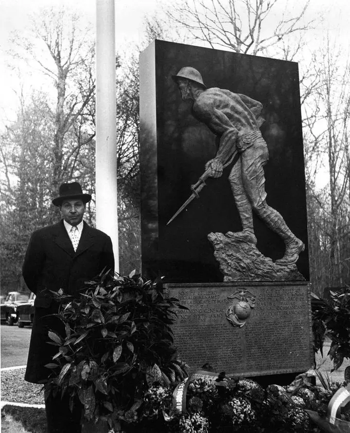 Sculptor Felix de Weldon beside his Marine Monument in Belleau Wood at its dedication, 18 November 1955