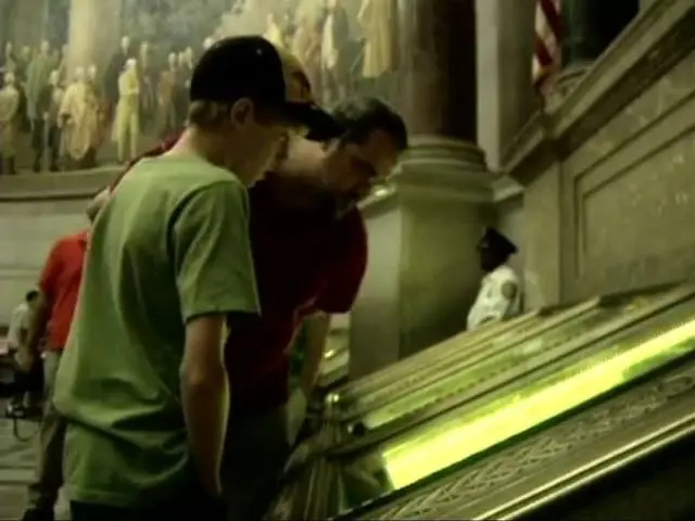 Visitors view the Constitution in the Rotunda of the National Archives (video still).