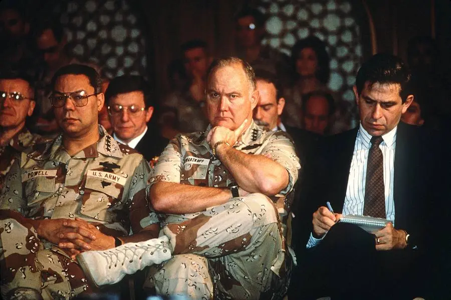 Gen. Colin Powell and Gen. Norman Schwarzkopf listen as Defense Secretary Dick Cheney answers the press, February 1991.