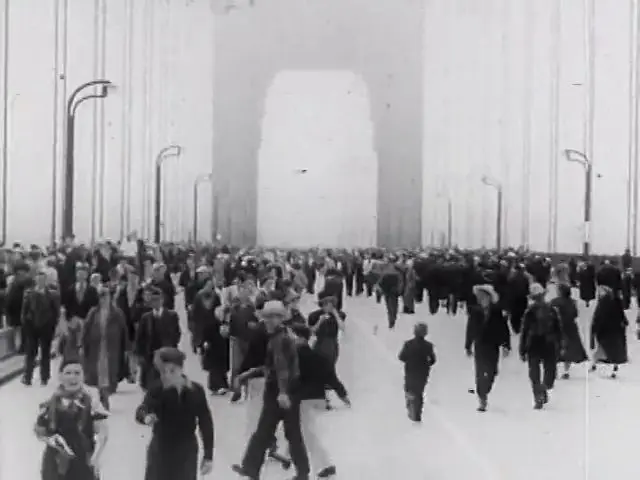 Crowds walk the deck on opening day, May 1937, in a frame from newsreel film.
