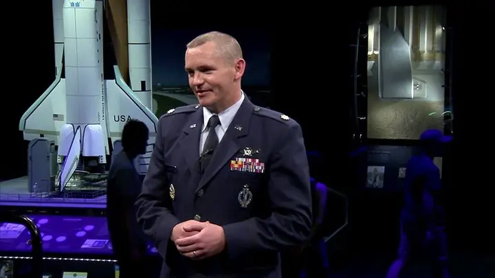 An Air Force officer speaks on GPS at the Smithsonian's National Air and Space Museum.