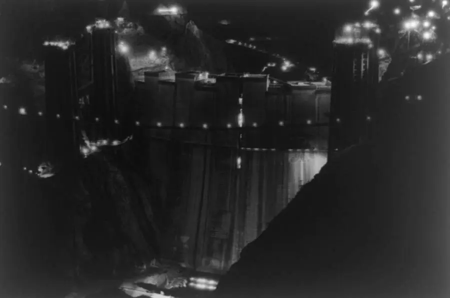 The upstream face of Boulder Dam lit for the night shift, photographed by Ben Glaha, c. 1934