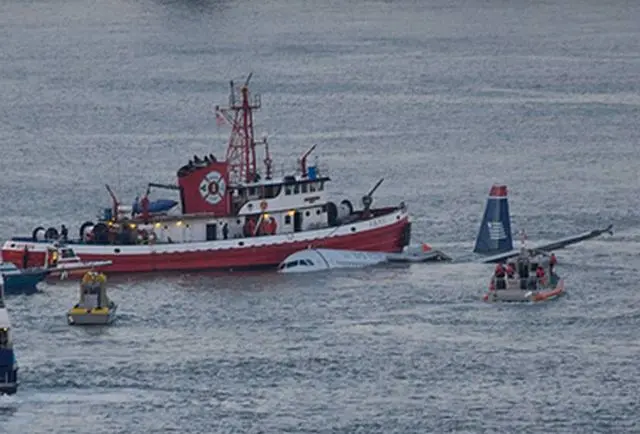 A New York City fireboat and rescue boats beside the sinking Airbus in the Hudson River