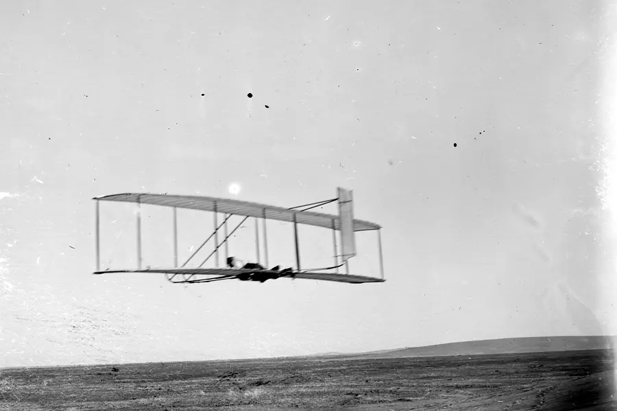 Wilbur Wright glides in level flight in the 1902 glider, Kill Devil Hills, N.C., October 17, 1902