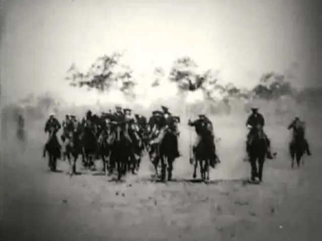 A troop of Rough Riders charges on horseback at Tampa before sailing for Cuba, 1898, in a Biograph film frame