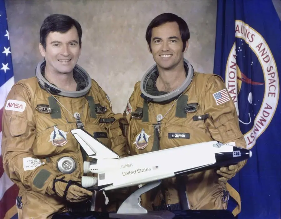 John Young and Bob Crippen, the STS-1 crew, with a model of the shuttle, official crew portrait, 1979 (KSC-79PC-0271)