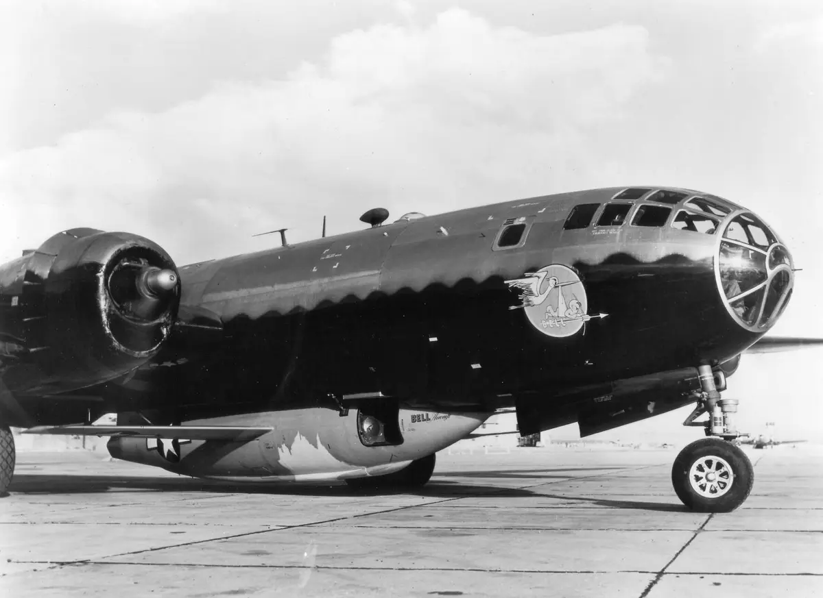 A first-generation Bell X-1 rides in the modified bomb bay of its B-29 Superfortress mothership.
