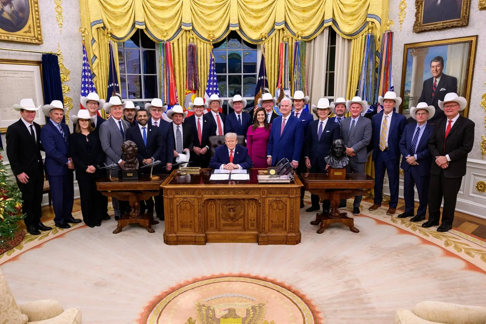Members of the 1980 team with President Trump in the Oval Office in December 2025, when he signed the Miracle on Ice Congressional Gold Medal Act