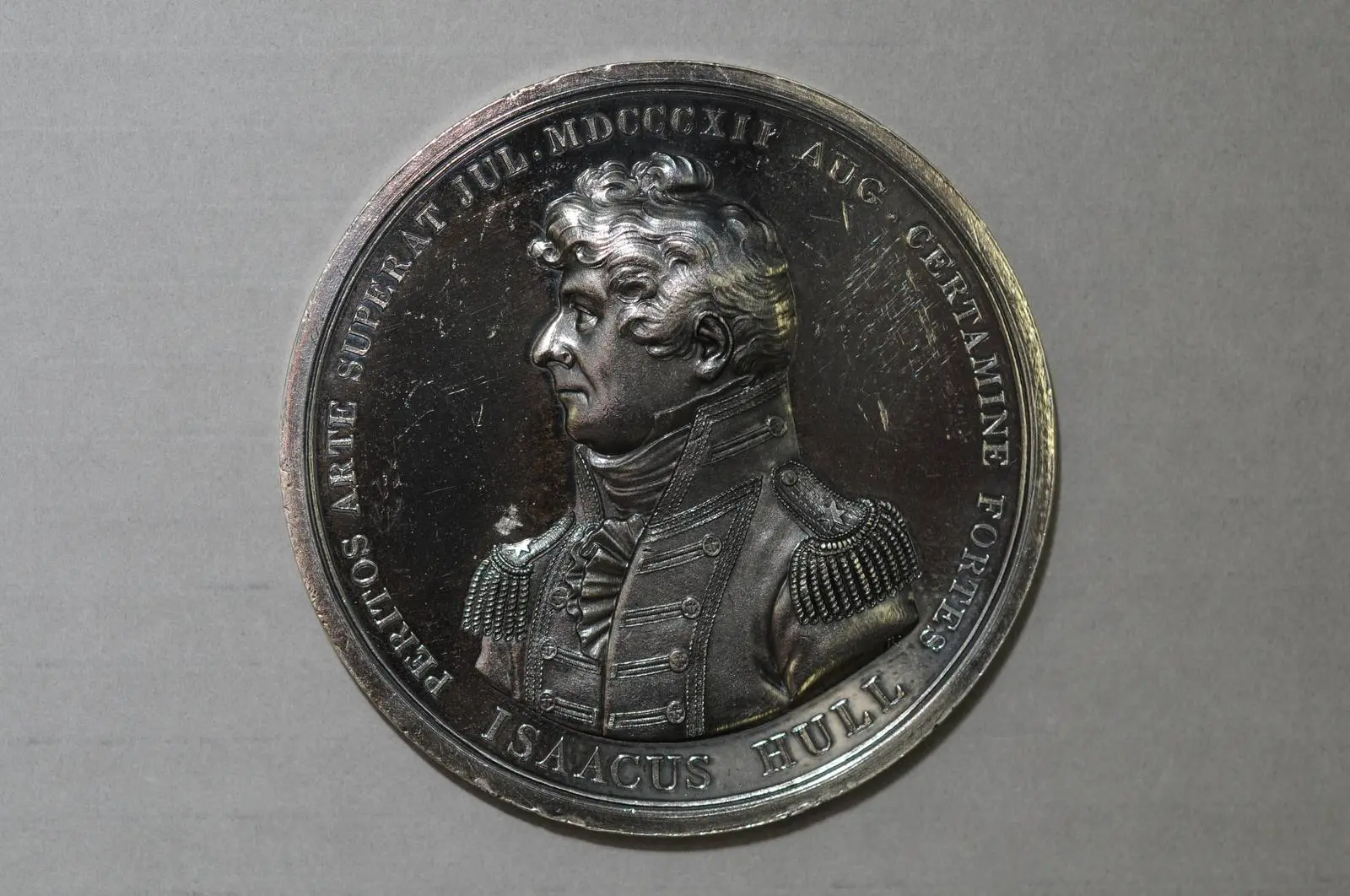 A silver striking of Isaac Hull’s Congressional Gold Medal. Its Latin honors his skill in the July escape and his courage in the August battle.